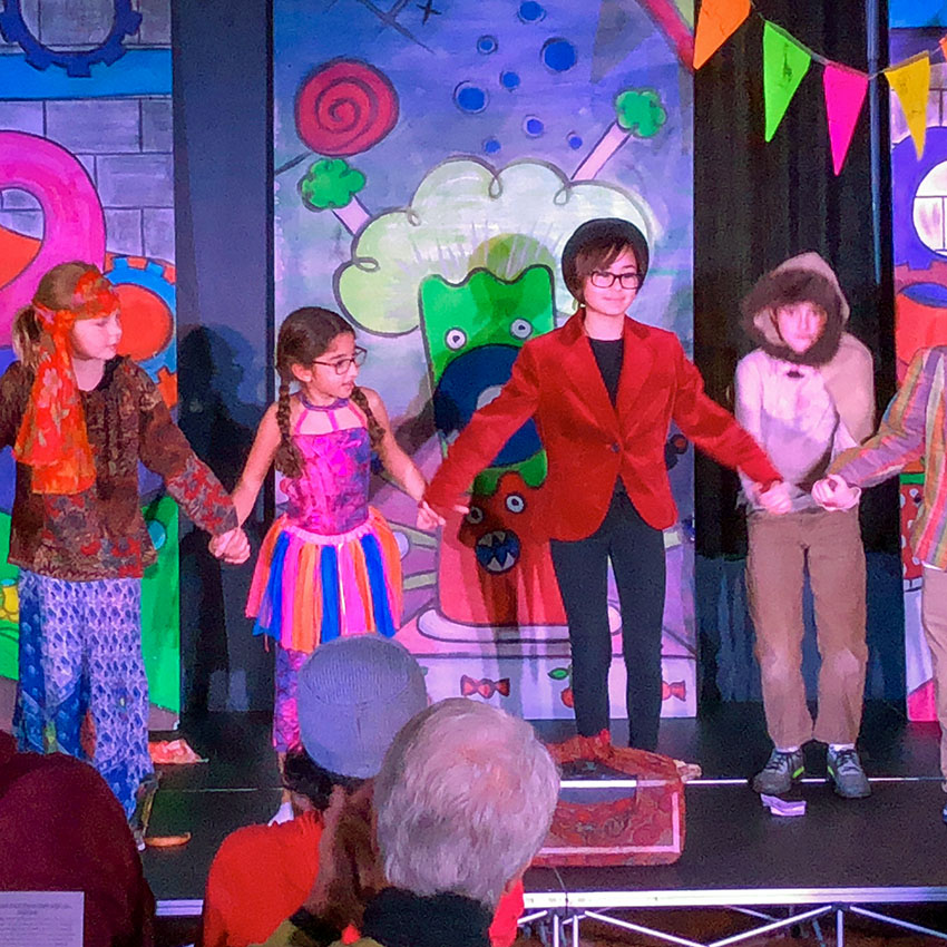 Education at Uptown class of young children on black box stage giving final performace to friends and family