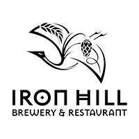 Iron Hill Brewery & Restaurant logo in black text with white background. Logo mark is a flying bird outlined in black with wheat and hops designed into the wings