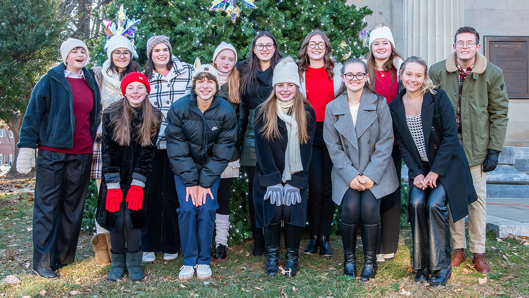 Two rows of uptown singers smiling at camera.